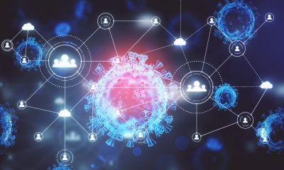 ose-up of virus cells coronavirus 2019-nCov and remote work hologram on screen. Coronavirus helath crisis and remote work concept. 3D Rendering